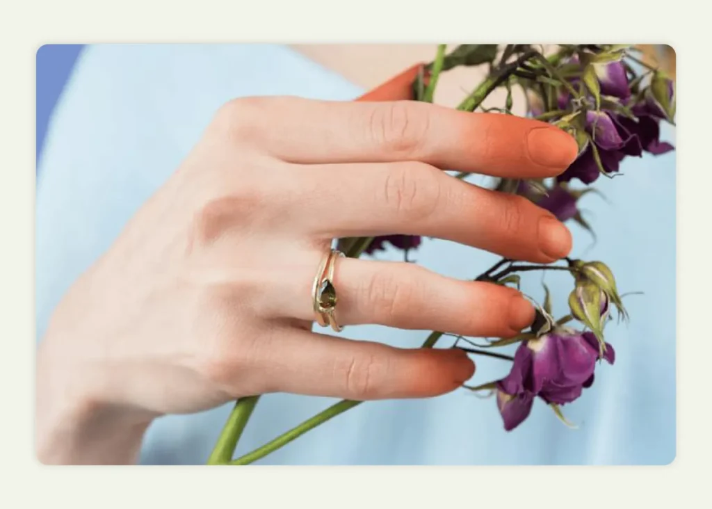 Gold constellation necklace displayed on dark blue background