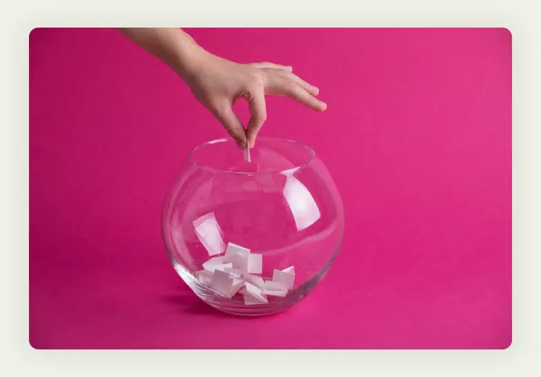 Clear container filled with chits for trade show prize drawing