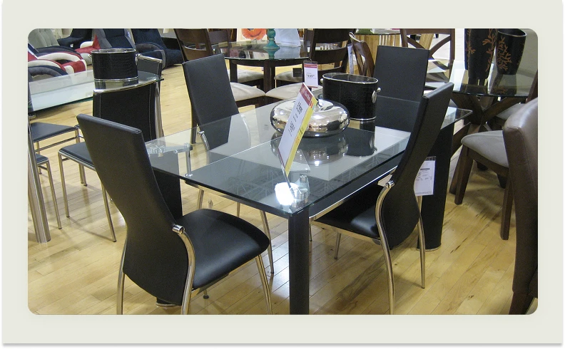 A product shot of a dining table with a cluttered background